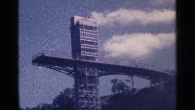1964: Low Angle View of Big Building Near Green Tree at Niagara Falls Canada