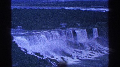 1964: nature's view overlooking a waterfall and forest during sunset.
