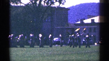 1964: soldiers walking down a field doing drills while marching