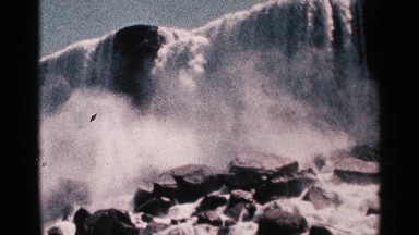 1964: Grounds Eye View of Niagara Falls Waterfall with Rushing Water and Mist