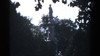 1964: A Green Garden Center with White Statue in Morning Light