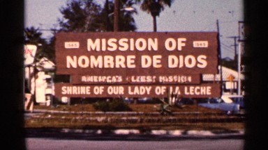1966: a board sign that represent a mission with its name car moving
