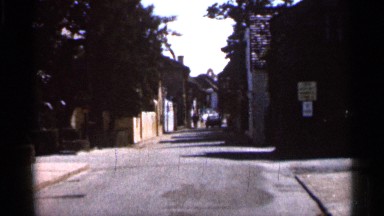 1966: a car driving away deep through a narrow lonely street. FLORIDA