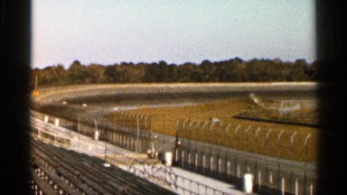 1966: empty seats in a large race track with no cars on the road. FLORIDA