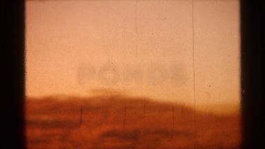 1966: The Colors of the Sunset Appear Over Silhouetted Mountain Ranges and Hills