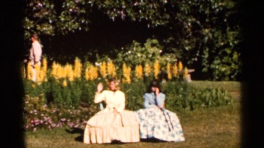 1966: people dressed in victorian garb enjoy a tropical garden FLORIDA