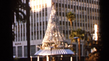1966: view of the christmas decorations in a city square during the sunset