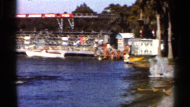 1966: a man skating in a water fast but missing for the water near building