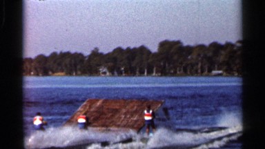 1966: three people water ski over a ramp in the water FLORIDA
