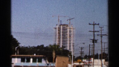 1966: big size building low angle view near the electrical post sign board