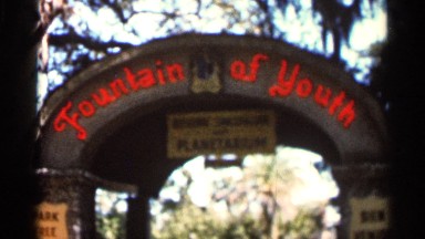 1966: Park Entry Gate Mentioning Fountain of Youth on a Shiny Day with Blue Sky