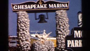 1966: sign announces chesapeake marina atop stone pillars framing boat FLORIDA