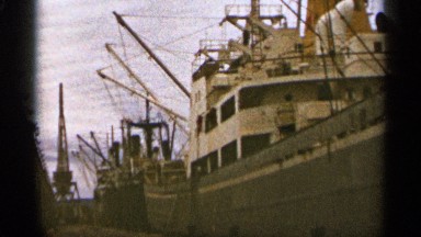 1965: two large ships remaining anchored near to the shore on a sunny day DULUTH