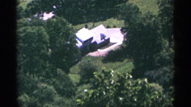 1965: it's taken by long view, shot of house and trees , vintage clip