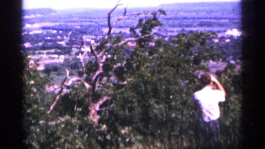 1965: man admiring nature by taking photographs of the outdoors