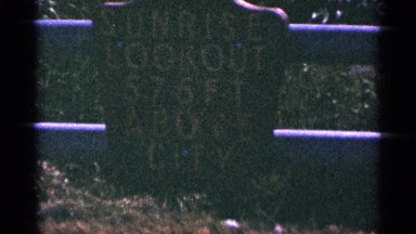 1965: a statue is shown and it's write a word is sunrise lookout above city