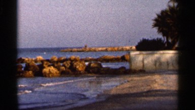 1966: nature look of a beach with man made things around the bay of the water
