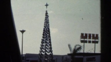 1966: the christmas tree is bright in behind of the city