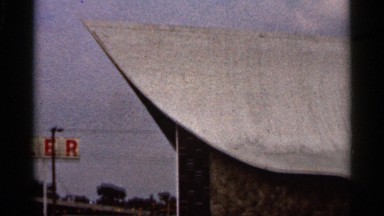 1966: big building view the low angle near to two plus symbol lamp and tree
