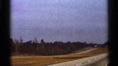 1966: a car goes down lonely highway in the countryside at daytime FLORIDA