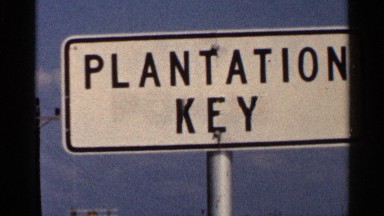 1966: white street sign for "plantation key" against blue sky FLORIDA