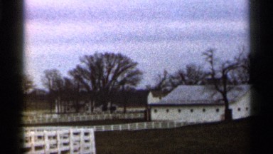 1966: shaky, old style video of a possible farm with trees