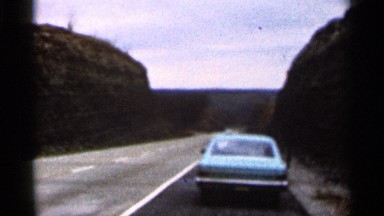 1966: a car parked nearby road surrounded by hills GEORGIA