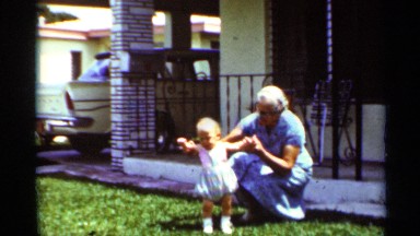1963: grandma having fun while showing baby how to learn to walk MISSISSIPPI