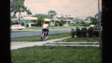 1963: Vintage Video of a Boy Riding a Bike on the Sidewalk in Mississippi