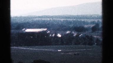 1964: a place that looks like an estate and some houses plants and ground