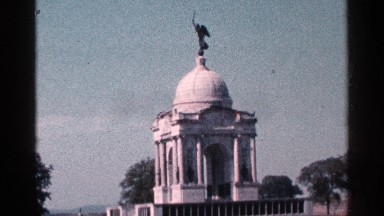 1964: a building is shown and the up of the building a metal statute