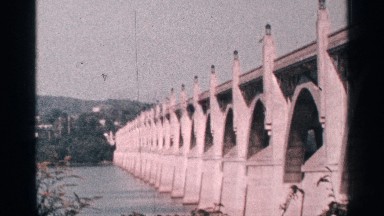 1964: beautiful dam structure with its reflection on the water underneath.