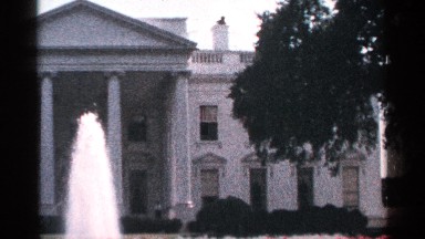 1964: a house with trees and a fountain is also in front of the house