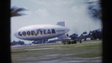 1958: a goodyear blimp is under control of a ground crew in a field FLORIDA