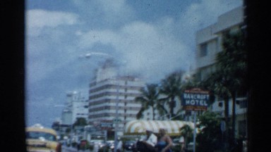 1958: the view from a vehicle moving along a busy city street