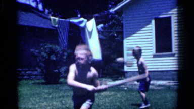 1958: small boy play in cricket house back side ground in morning time