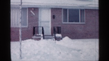 1958: closed two houses are located near and a car parking between the two