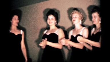 1958: four women are enjoying stage performance with unique color dress code