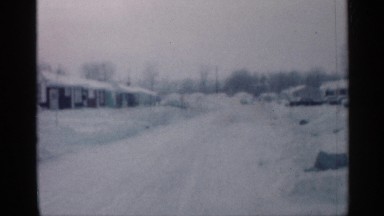 1958: car driving down a snow covered street. NEW JERSEY