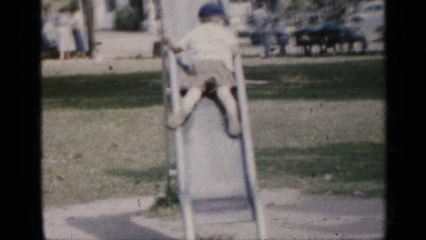 1958: child slides down metal slide backwards in the park NEW JERSEY