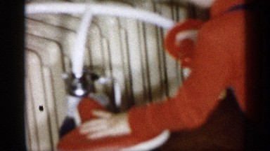 1959: kid playing and enjoying in her home with her parents,around sofa chair