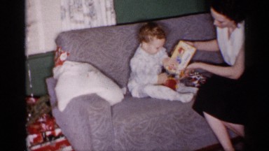 1959: a cute baby playing with his toys given to him by his mother. MICHIGAN