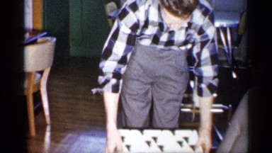 1959: man opening present on chair MICHIGAN