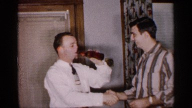1959: two men shaking hands each other and driving bear MICHIGAN