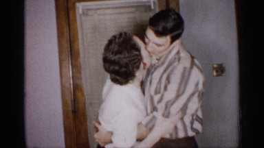 1959: a young men and women kiss for the our house back side door wood lamp