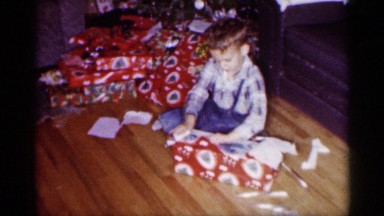 1959: a boy unwrapping a christmas gift MICHIGAN
