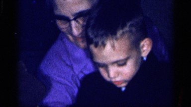 1959: child receives easter basket, surrounded by family members. MICHIGAN