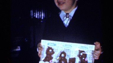 1959: the baby and the men are shown in the video file they kiss the child