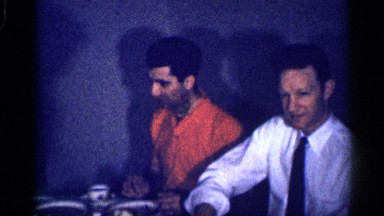 1959: family having dinner and a kid in it playing with his food and guest