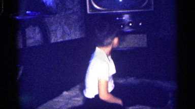 1959: boy playing on a blanket in front of a floor model tv. MICHIGAN